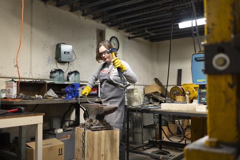 A student group, Materials Advantage, works to create a blade in a smithing shop