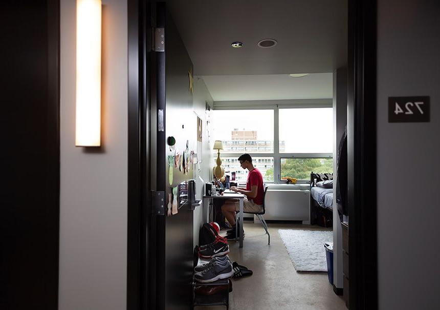 A student studies in their room in Kacek Hall