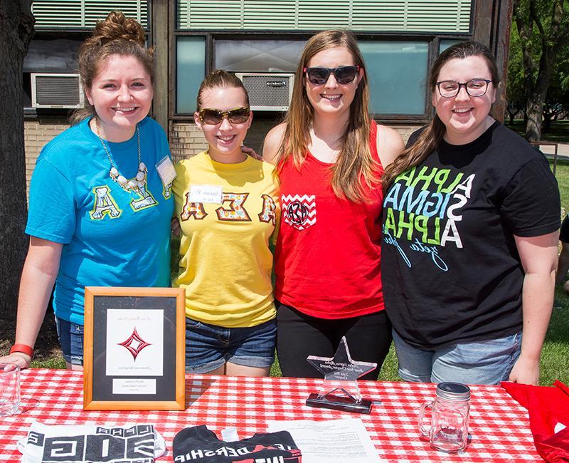 Female students from a greek organization standing together outside