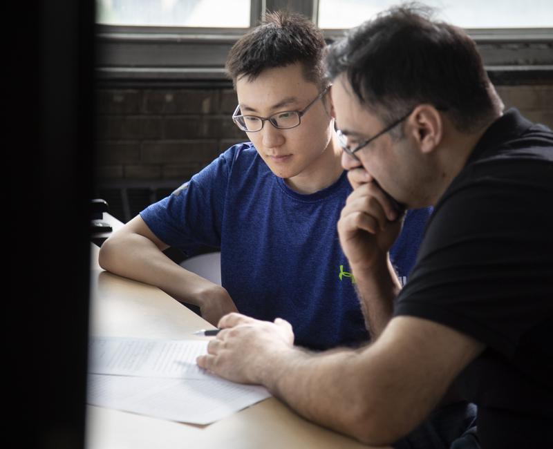 A student has a paper edited in the writing center